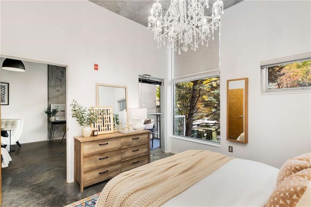 bedroom with finished concrete flooring, a towering ceiling, and a chandelier