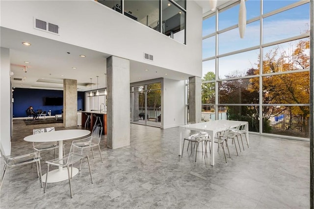 dining room featuring recessed lighting, a high ceiling, visible vents, and marble finish floor