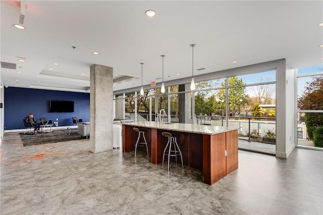 bar featuring visible vents, a sink, recessed lighting, and hanging light fixtures