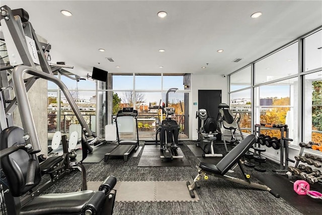 workout area featuring a wall of windows and recessed lighting