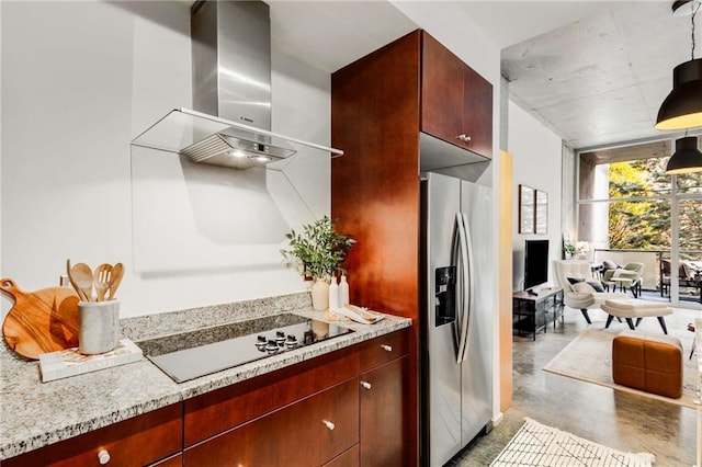 kitchen with pendant lighting, black electric stovetop, stainless steel refrigerator with ice dispenser, wall chimney exhaust hood, and finished concrete floors