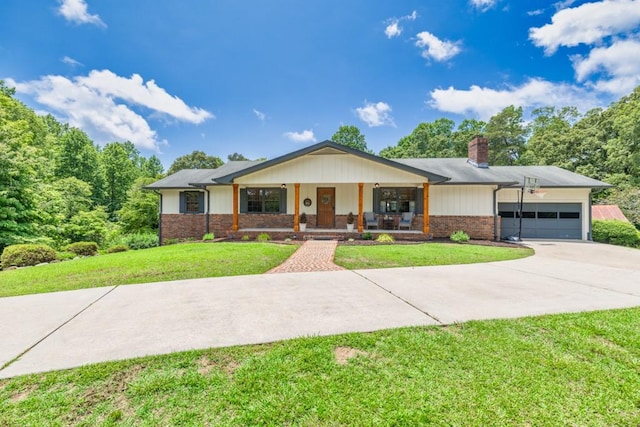 6127 Yellow Creek Rd, Murrayville, GA 30564 - view of front of house featuring covered porch, concrete driveway, a chimney, a garage, and a front lawn