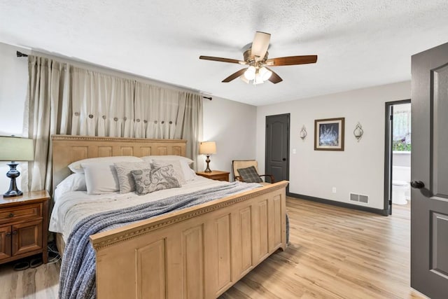 6127 Yellow Creek Rd, Murrayville, GA 30564 - bedroom with baseboards, light wood-style flooring, a ceiling fan, and a textured ceiling