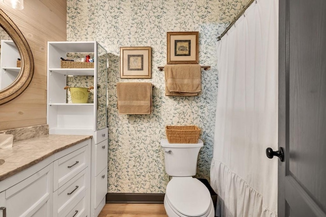 6127 Yellow Creek Rd, Murrayville, GA 30564 - bathroom featuring wallpapered walls, vanity, toilet, wood finished floors, and baseboards