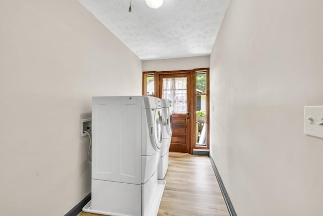 6127 Yellow Creek Rd, Murrayville, GA 30564 - laundry area featuring washing machine and dryer, light wood-type flooring, a textured ceiling, and baseboards