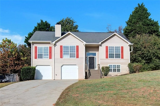 split foyer home with a garage and a front yard