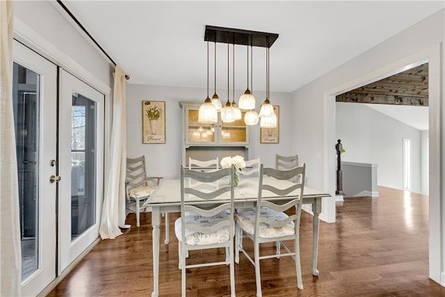 dining space with dark wood finished floors and french doors