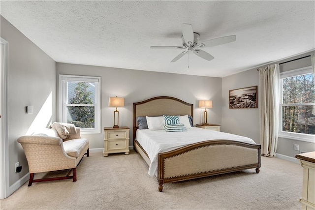 bedroom with baseboards, multiple windows, and light colored carpet