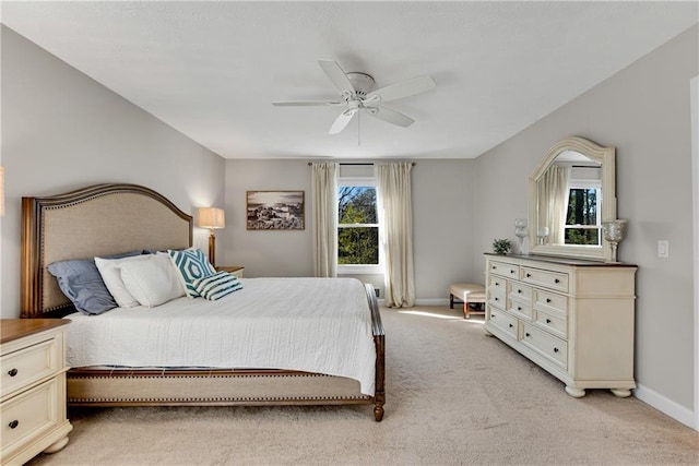 bedroom featuring a ceiling fan, baseboards, and light carpet