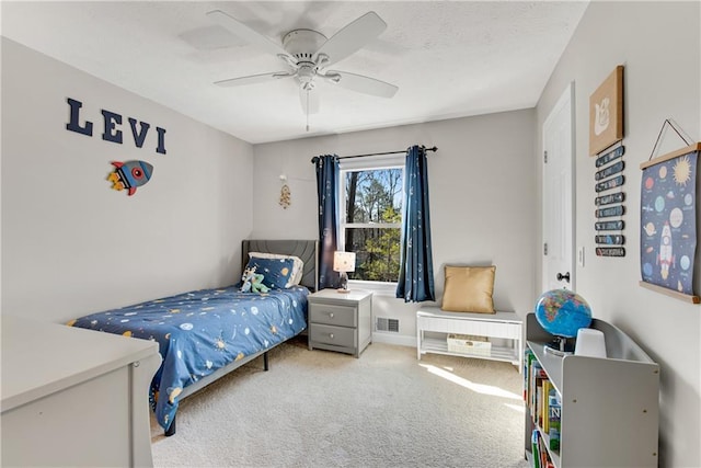 carpeted bedroom with visible vents, a textured ceiling, and a ceiling fan