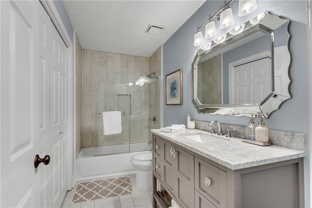 bathroom featuring visible vents, toilet, a textured ceiling, bath / shower combo with glass door, and vanity