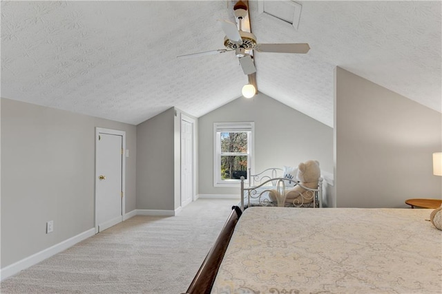 bedroom featuring baseboards, carpet floors, a textured ceiling, and vaulted ceiling