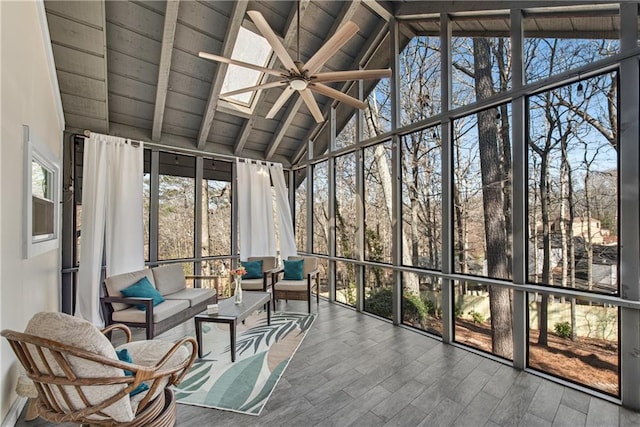 sunroom / solarium with vaulted ceiling with skylight and ceiling fan