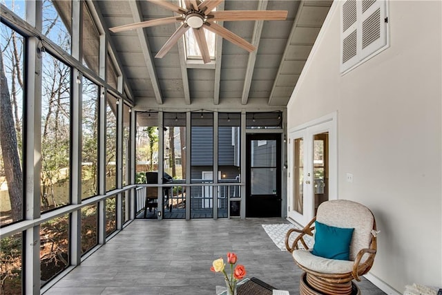 unfurnished sunroom with lofted ceiling with beams, visible vents, and ceiling fan