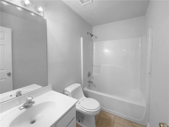 full bathroom with visible vents, toilet, washtub / shower combination, vanity, and tile patterned floors