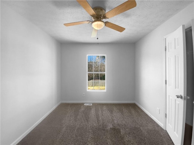 unfurnished room featuring carpet, visible vents, a textured ceiling, and baseboards