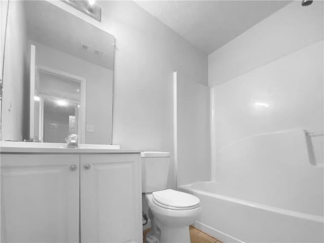 full bath featuring toilet, shower / bathing tub combination, vanity, and visible vents