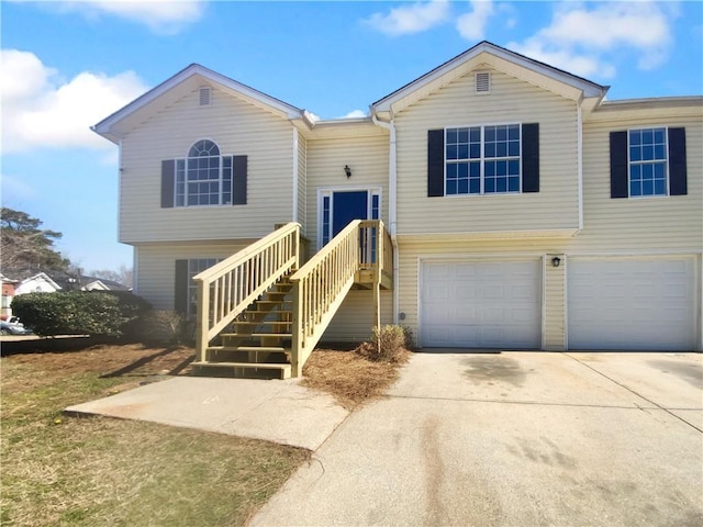 bi-level home with driveway and a garage