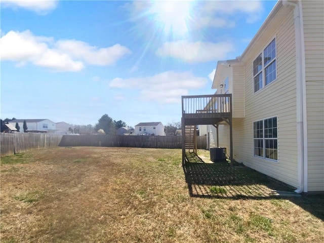 view of yard featuring fence, cooling unit, and a wooden deck