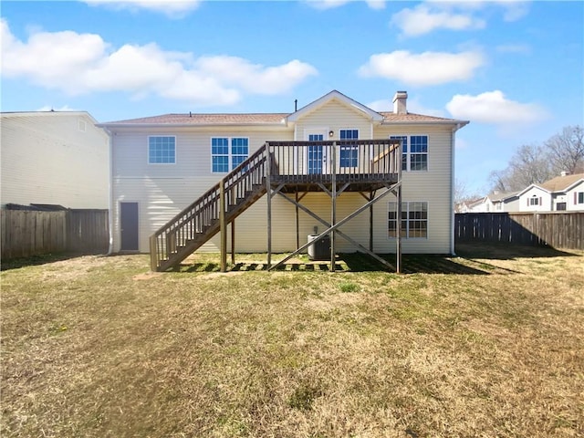 back of house featuring a deck, a yard, stairway, and a fenced backyard