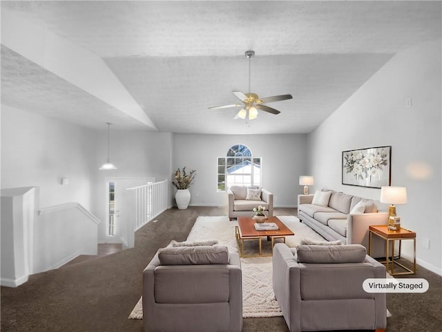 living room with a ceiling fan, baseboards, vaulted ceiling, and carpet flooring