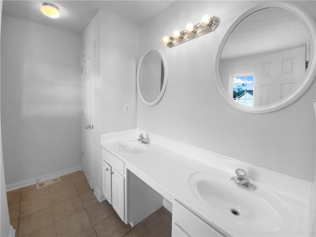 bathroom featuring double vanity, visible vents, a sink, and tile patterned floors