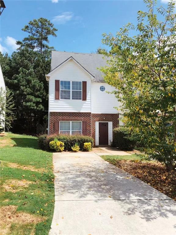 301 Brookview Dr, Riverdale, GA 30274 - traditional home featuring brick siding, concrete driveway, and a front lawn