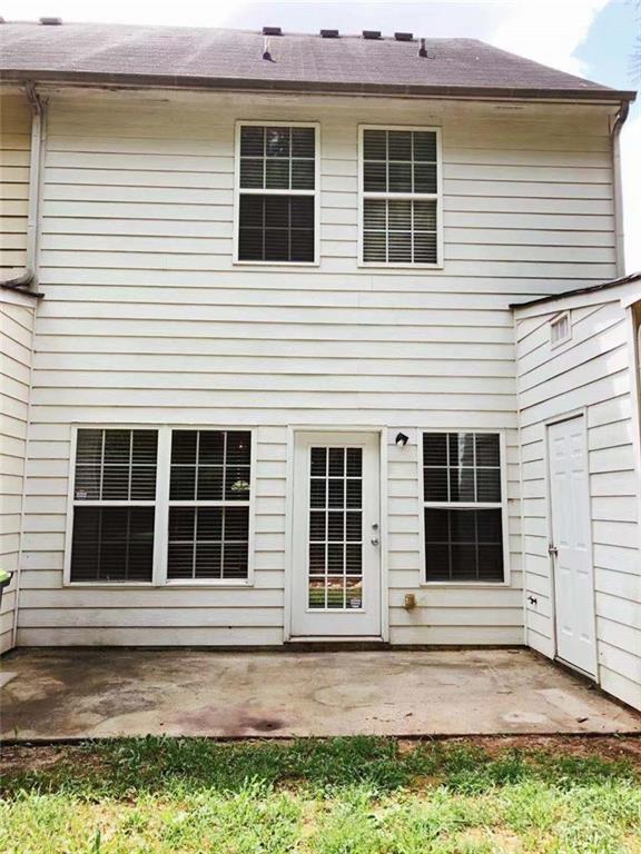 301 Brookview Dr, Riverdale, GA 30274 - rear view of property featuring a patio area and a shingled roof