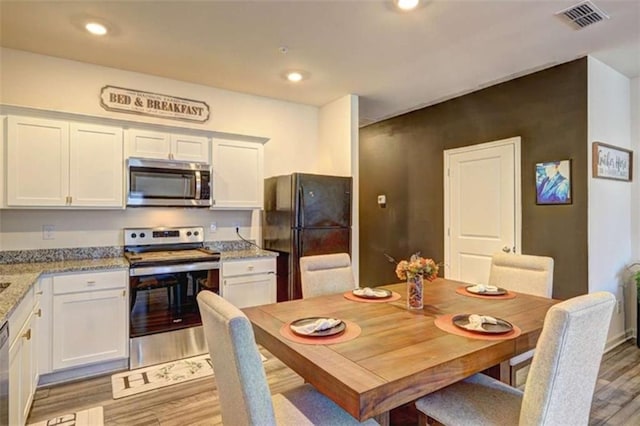 dining area with recessed lighting, visible vents, and light wood-style floors