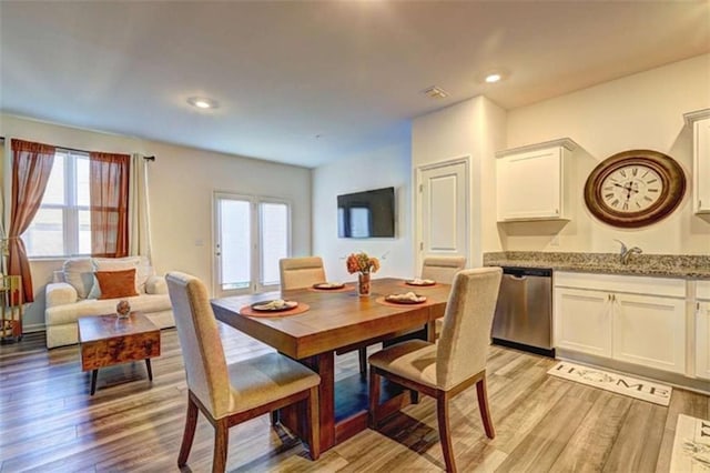 dining room featuring light wood finished floors, visible vents, and recessed lighting