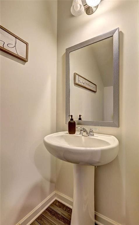 bathroom with baseboards and wood finished floors