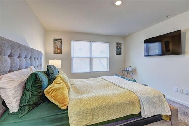 carpeted bedroom featuring baseboards