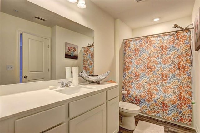 full bathroom featuring visible vents, curtained shower, toilet, and vanity