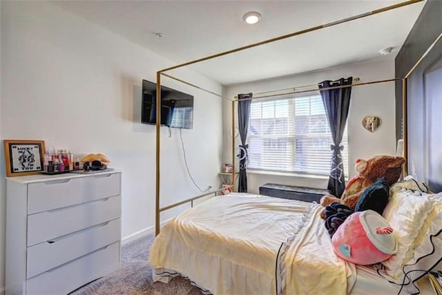 bedroom featuring baseboards and carpet