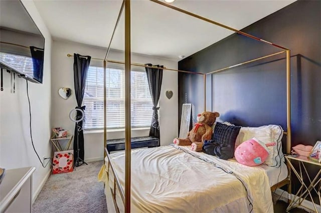 bedroom featuring baseboards and carpet flooring