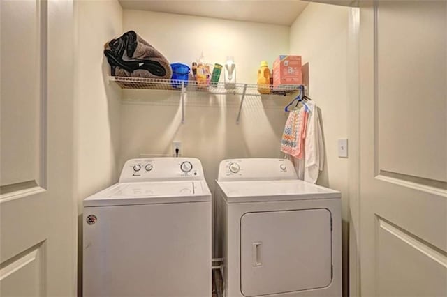 laundry room featuring washing machine and dryer and laundry area