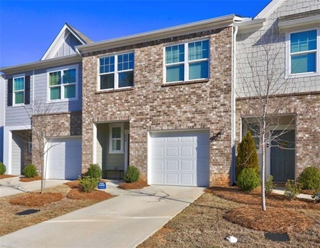 view of front of house featuring an attached garage, brick siding, and driveway