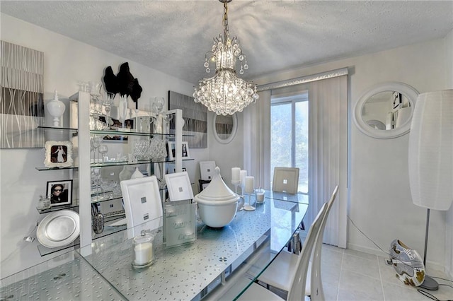 tiled dining space featuring a textured ceiling and a notable chandelier