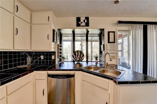 kitchen featuring stainless steel dishwasher and white cabinetry