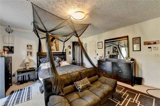 bedroom with a textured ceiling and dark colored carpet