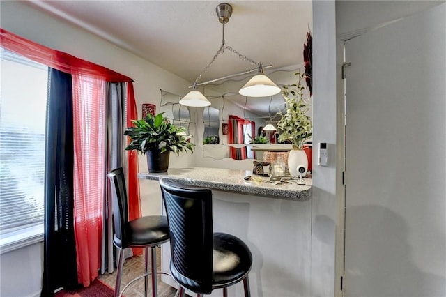 kitchen with pendant lighting and a breakfast bar