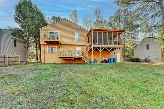 back of property featuring a lawn, central air condition unit, a sunroom, and a balcony