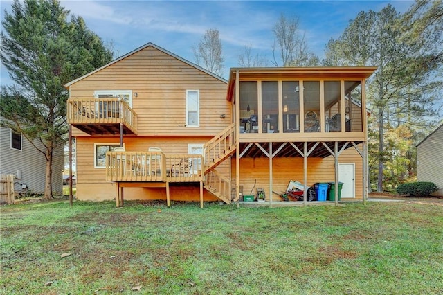 rear view of property with a sunroom and a yard