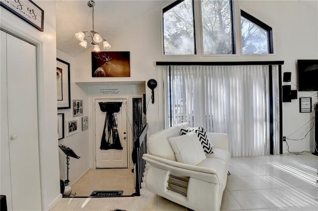 tiled entryway with high vaulted ceiling and an inviting chandelier