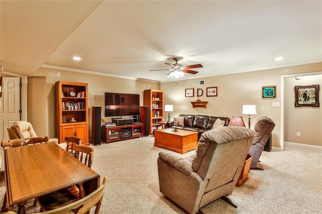 carpeted living room with ornamental molding and ceiling fan