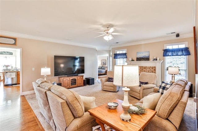 living room with ornamental molding, a healthy amount of sunlight, ceiling fan, and light hardwood / wood-style floors