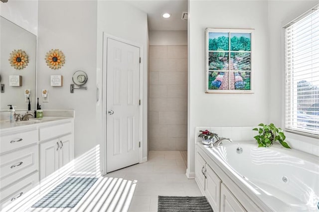 bathroom with vanity, a bath, and tile patterned floors