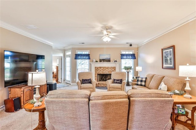 carpeted living room with a brick fireplace, crown molding, and ceiling fan