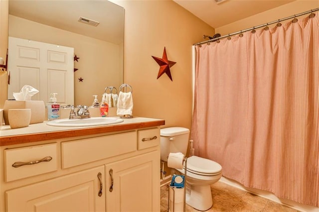 bathroom with vanity, tile patterned floors, and toilet