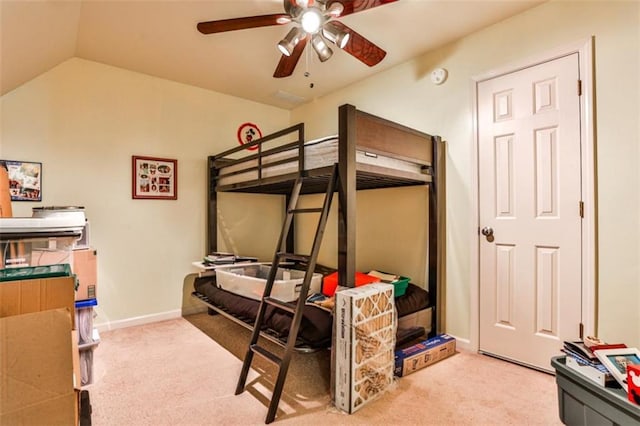 bedroom featuring vaulted ceiling, light carpet, and ceiling fan